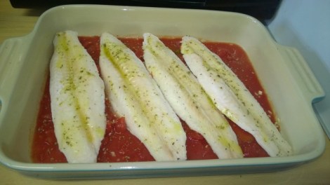 Fish and tomatoes in dish